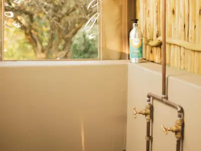 a bottle of soap sitting on a window sill at The Leadwood Safari Camp in Dinokeng Game Reserve