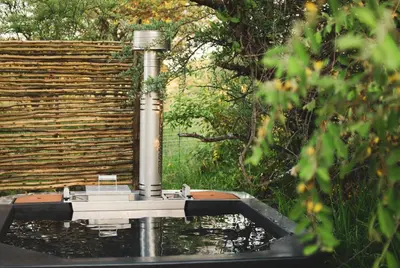 a fountain in front of a wooden fence at The Leadwood Safari Camp in Dinokeng Game Reserve