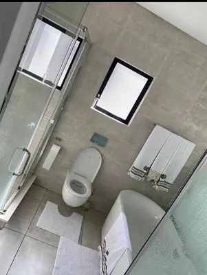 a bathroom with a toilet and a tub and a sink at Le Bon Dieu in Midrand