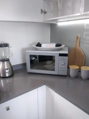 a microwave oven sitting on a counter in a kitchen at Le Bon Dieu in Midrand
