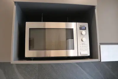 a microwave oven in a cabinet in a kitchen at Comfort at 1503 Menlyn Maine Residences in Pretoria