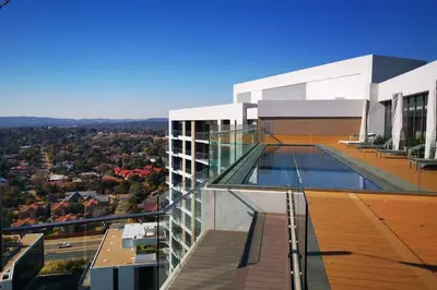 a building with a swimming pool on top of it at Comfort at 1503 Menlyn Maine Residences in Pretoria