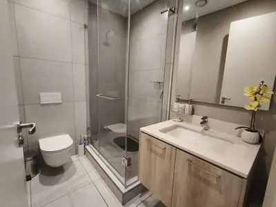 a bathroom with a shower and a sink and a toilet at Comfort at 1503 Menlyn Maine Residences in Pretoria