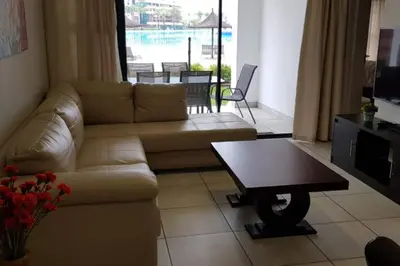 a living room with a couch and a coffee table at Blyde 3 bed Lagoon View Apartment in Pretoria