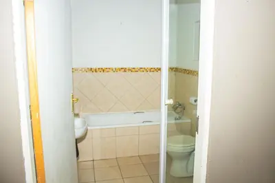 a bathroom with a tub and a toilet and a sink at @431 Rupert Street in Pretoria