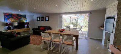 a living room with a wooden table and chairs at DullVino First House in Dullstroom