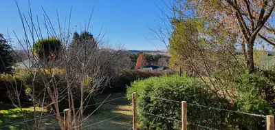 a garden with a fence and some bushes and trees at DullVino First House in Dullstroom