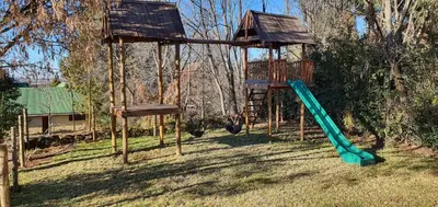 a playground with a slide and a tree house at DullVino First House in Dullstroom