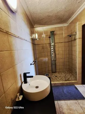 a bathroom with a sink and a shower at Romantic Getaway Hartbeespoort in Hartbeespoort