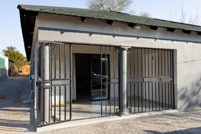 a garage with bars on the side of a building at The Hide On Claremont in Pretoria