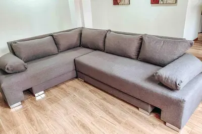 a grey couch in a room with a wooden floor at Pecanwood Golf Estate Home - Hartbeespoort in Hartbeespoort