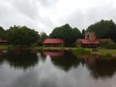 a view of a lake with houses and a building at Critchley Hackle - Tower rooms in Dullstroom