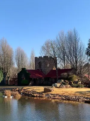 a large building next to a body of water at Critchley Hackle - Tower rooms in Dullstroom