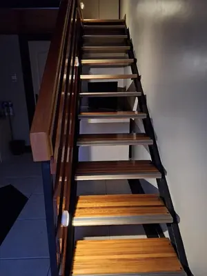 a set of wooden stairs in a room at Jabliano Guest House in Secunda