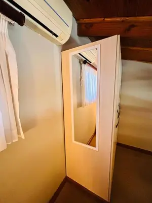 a door with a mirror in a room at Jabliano Guest House in Secunda