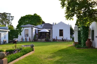 a large white house with a yard with a grass yard at The Gables Guest House in Belfast