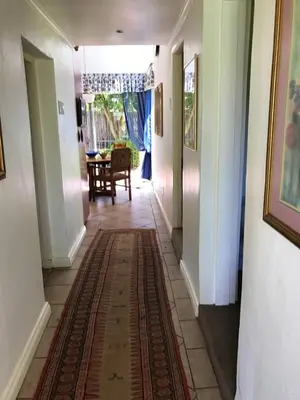 a hallway of a house with a rug on the floor at The Gables Guest House in Belfast