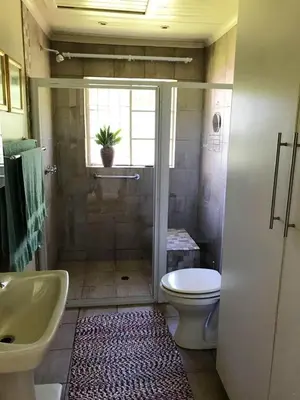 a bathroom with a shower and a toilet and a sink at The Gables Guest House in Belfast