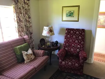 a living room with a couch and a chair at The Gables Guest House in Belfast
