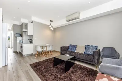a living room with a couch and a table at The Regency Apartments in Pretoria