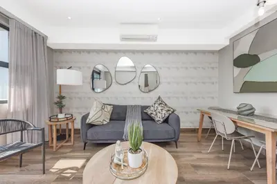 a living room with a couch and a table at The Regency Apartments in Pretoria