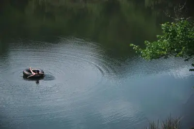 a person swimming in a body of water at AfriCamps Magoebaskloof in Magoebaskloof