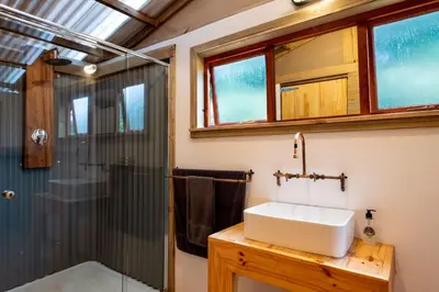 a bathroom with a sink and a shower at AfriCamps Magoebaskloof in Magoebaskloof