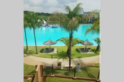 a view of the pool from the balcony of a resort at Apartment 432 @ The Blyde Riverwalk Pretoria in Pretoria