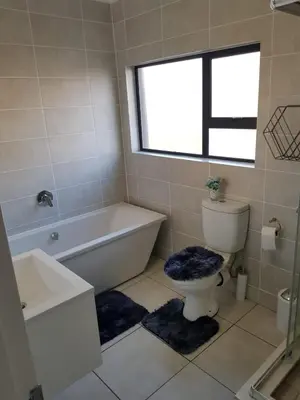 a bathroom with a tub and a toilet and a sink at Apartment 432 @ The Blyde Riverwalk Pretoria in Pretoria