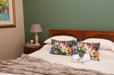 a bed with a stuffed animal sitting on top of it at Ben's Bed and Breakfast in Pretoria