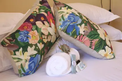 a bed with two pillows and a towel on it at Ben's Bed and Breakfast in Pretoria