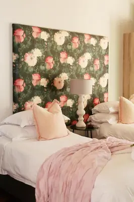 a bedroom with two beds with a floral wallpaper at Ben's Bed and Breakfast in Pretoria
