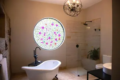 a bathroom with a tub and a shower with a window at Ben's Bed and Breakfast in Pretoria