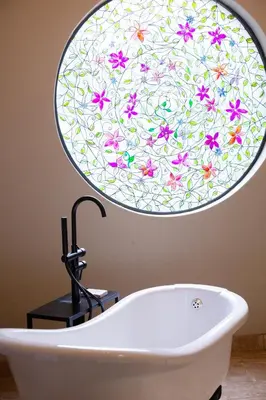 a bathroom with a bath tub with a flower pattern on the wall at Ben's Bed and Breakfast in Pretoria