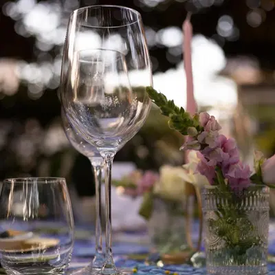 two wine glasses sitting on a table with flowers at Ben's Bed and Breakfast in Pretoria