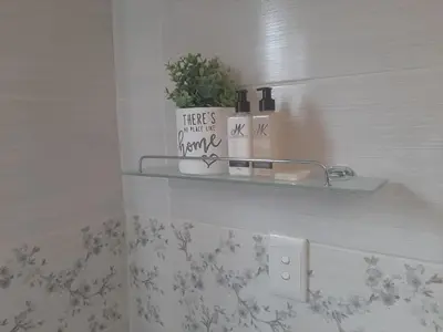 a bathroom with a shelf with a plant on it at Lesedi Self Catering in Pretoria
