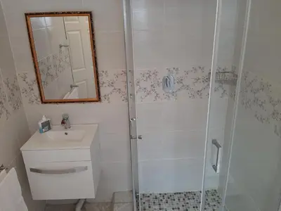 a bathroom with a shower and a sink at Lesedi Self Catering in Pretoria