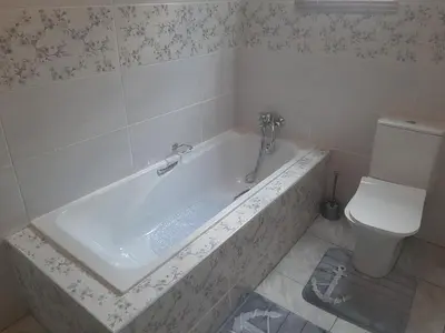 a bathroom with a bath tub and a toilet at Lesedi Self Catering in Pretoria