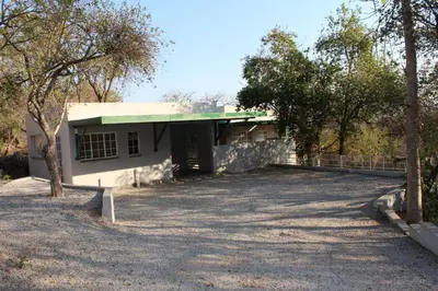 a white house with a green roof at Tucked-Away 1&2 Bedroom Houses in Nelspruit