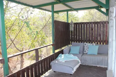 a pergola with a couch sitting on a deck at Tucked-Away 1&2 Bedroom Houses in Nelspruit