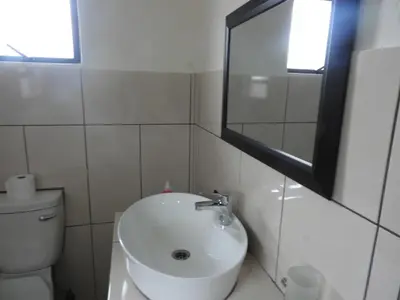 a white bathroom with a sink and a toilet at Bongan Safari Lodge in Mbabat
