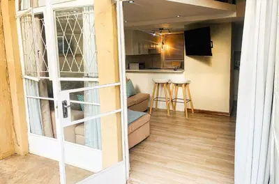 a door leading to a living room and a kitchen at The Loft@Santorini in Pretoria