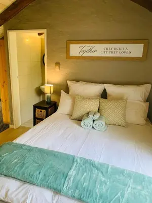 a bedroom with a bed with two towels on it at The Loft@Santorini in Pretoria