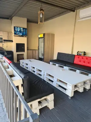 a room with two ping pong tables and a couch at SummerField Guest House in eNyamazaneni