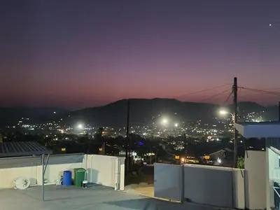 a view of a city at night with lights at SummerField Guest House in eNyamazaneni