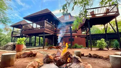 a house with a fire pit in front of it at Kruger Kumba - Mugwenzi in Marloth Park