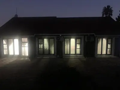 a house at night with the lights on at Waterfall View Lodge in Midrand