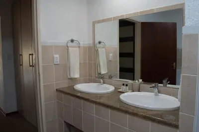 a bathroom with two sinks and a large mirror at Kruger Park Lodge Unit 245 in Hazyview