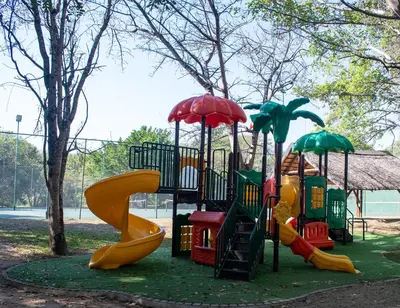 a playground with slides and umbrellas in a park at Kruger Park Lodge Unit 245 in Hazyview