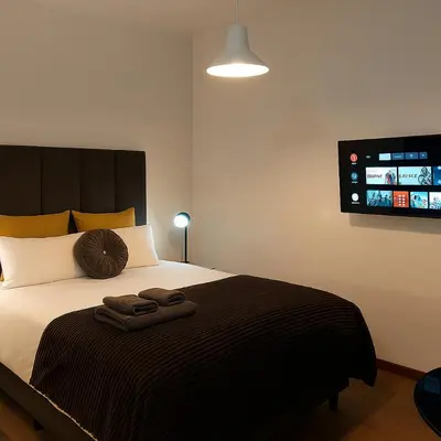 a bedroom with a bed with two towels on it at Ratel Street Guesthouse in Pretoria